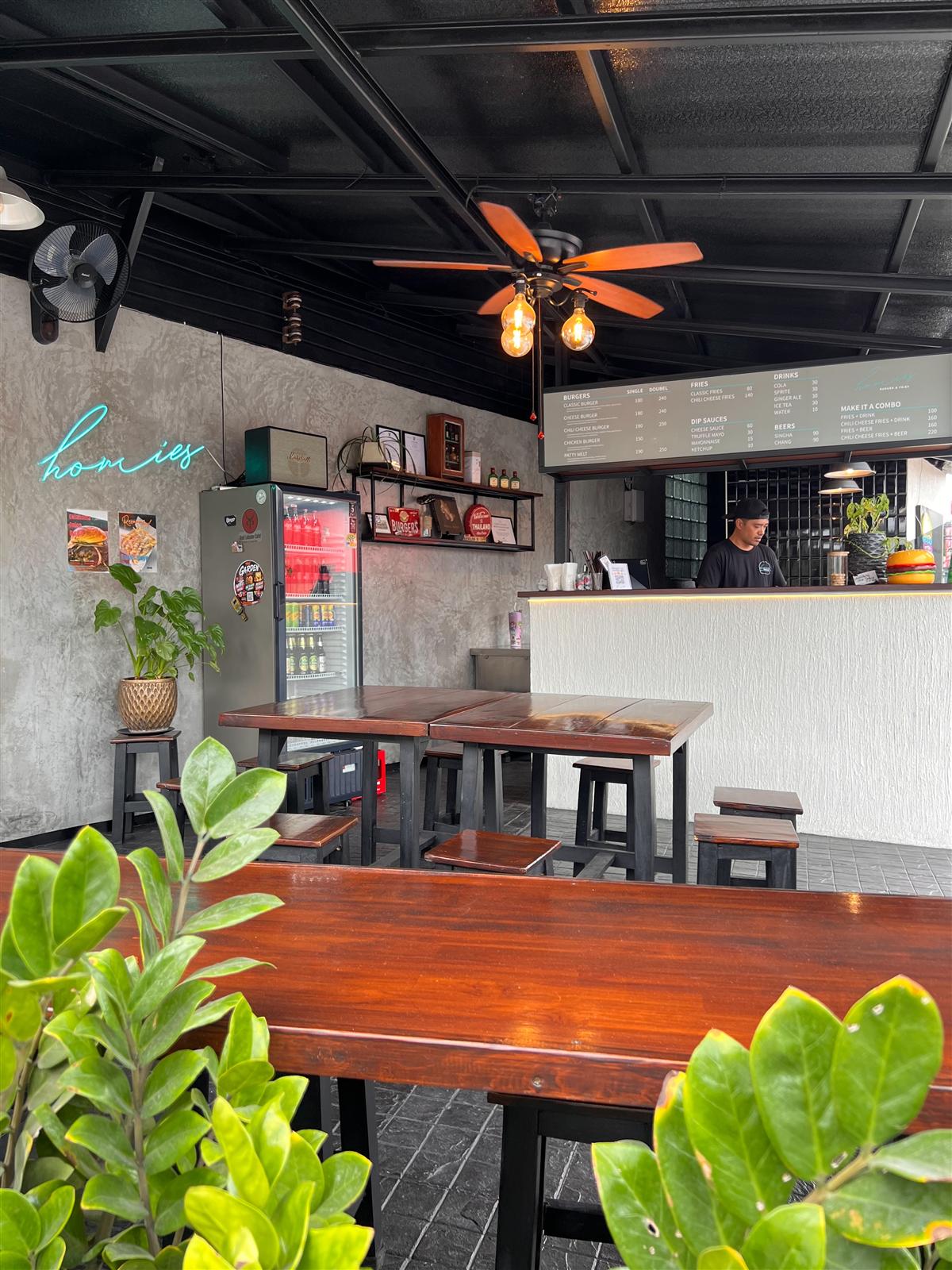 The order counter at Homies Burger and Fries with the menu board overhead
